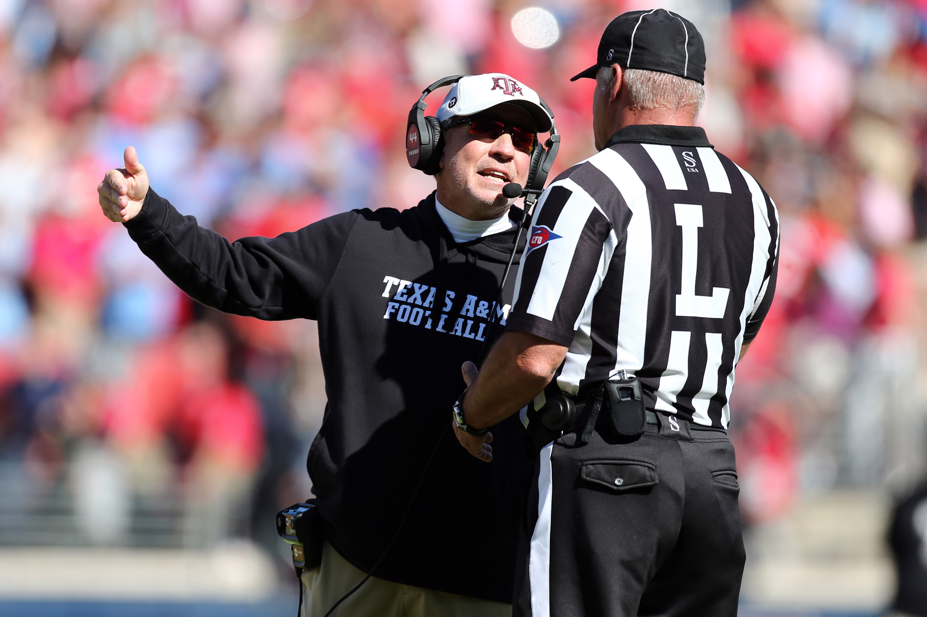Nov 4, 2023; Oxford, Mississippi, USA; Texas A&M Aggies head coach Jimbo Fisher talks to a referee during the first half against the Mississippi Rebels at Vaught-Hemingway Stadium.